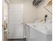 Laundry room area featuring a washing machine, dryer, and overhead shelving for convenient storage at 2479 Glen Dr., Little River, SC 29566
