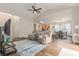 Spacious living room boasts vaulted ceilings, wood floors, and a seamless transition to the kitchen and dining area at 2479 Glen Dr., Little River, SC 29566