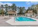 Community pool area with pool, deck furniture, cabana, and meticulously maintained grounds at 2479 Glen Dr., Little River, SC 29566