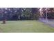 This backyard features a green lawn, trees, and a chainlink fence at 289 Whites Creek Rd., Georgetown, SC 29440