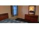 This bedroom features a floral mattress, wooden headboard and dresser with a mirror to reflect the room at 289 Whites Creek Rd., Georgetown, SC 29440