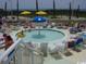 Fun pool featuring an umbrella fountain and seating areas for a refreshing and enjoyable experience at 304 N Ocean Blvd. # 1113, North Myrtle Beach, SC 29582