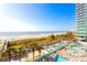 A beachside pool area with palm trees, lounge chairs, and ocean views at 304 N Ocean Blvd. # 1113, North Myrtle Beach, SC 29582