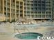 Luxury building with pool, hot tub, and lounge chairs for outdoor relaxation and enjoyment at 304 N Ocean Blvd. # 1113, North Myrtle Beach, SC 29582
