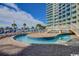 Outdoor pool area featuring a lazy river and multiple lounge chairs at 304 N Ocean Blvd. # 1113, North Myrtle Beach, SC 29582