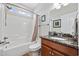 Well-lit bathroom with a granite vanity, shower and bathtub combo, and neutral decor at 310 Babylon Pine Dr., Myrtle Beach, SC 29579