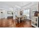 Elegant dining room with a chandelier, hardwood floors, tray ceilings, and large windows offering natural light at 310 Babylon Pine Dr., Myrtle Beach, SC 29579