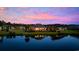Waterfront property with beautiful landscaping and stunning sunset views reflected in the calm water at 310 Babylon Pine Dr., Myrtle Beach, SC 29579