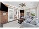 Bright sunroom featuring large windows, a plush sofa, and white french doors to another room at 310 Babylon Pine Dr., Myrtle Beach, SC 29579
