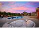 Beautiful backyard featuring a pool, outdoor kitchen, and lounge seating, perfect for entertaining guests at 310 Babylon Pine Dr., Myrtle Beach, SC 29579