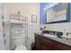 Bathroom featuring a wooden vanity with black countertop, chrome fixtures, and a decorative silver tin ceiling accent at 314 Lyons Cove Dr., Myrtle Beach, SC 29577