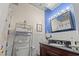 Bathroom featuring a wooden vanity with black countertop, chrome fixtures, and a decorative silver tin ceiling accent at 314 Lyons Cove Dr., Myrtle Beach, SC 29577
