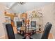 Cozy dining area adjacent to kitchen with glass table, black chairs, and decorative accents, filled with natural light at 314 Lyons Cove Dr., Myrtle Beach, SC 29577