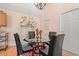 Elegant dining area with glass table, black chairs, and decorative accents, creating a welcoming atmosphere at 314 Lyons Cove Dr., Myrtle Beach, SC 29577