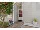 Charming front entrance with a decorative flower pot, gravel, and ornamental tree at 314 Lyons Cove Dr., Myrtle Beach, SC 29577