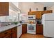 Traditional kitchen features wood cabinets, granite countertops, and modern appliances at 314 Lyons Cove Dr., Myrtle Beach, SC 29577