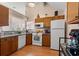 Functional kitchen with white appliances, granite countertops, and wood cabinetry providing ample storage space at 314 Lyons Cove Dr., Myrtle Beach, SC 29577