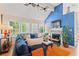 Cozy living room with vaulted ceilings, fireplace, hardwood floors, and lots of natural light from large windows at 314 Lyons Cove Dr., Myrtle Beach, SC 29577