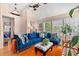 Bright living room featuring a vaulted ceiling, hardwood floors, and a comfortable seating area by large windows at 314 Lyons Cove Dr., Myrtle Beach, SC 29577