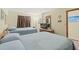 Inviting bedroom featuring twin beds, soft lighting, and a dresser with a television for a comfortable stay at 3211 S Ocean Blvd. # 204, Myrtle Beach, SC 29577