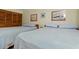Comfortable bedroom with two queen beds, soft blue bedding and simple nautical decor at 3211 S Ocean Blvd. # 204, Myrtle Beach, SC 29577