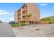Beautiful exterior view of elevated condo building with private balconies and convenient covered parking at 3211 S Ocean Blvd. # 204, Myrtle Beach, SC 29577