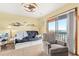 Living room offers a cozy sitting area with a futon, accent chair, and beach views at 3211 S Ocean Blvd. # 204, Myrtle Beach, SC 29577