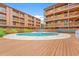 Community pool surrounded by sun deck and multi-story condominium buildings at 3211 S Ocean Blvd. # 204, Myrtle Beach, SC 29577