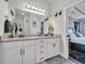Bathroom featuring double vanity with granite countertops, white cabinets, and access door to main bedroom at 338 St. Julian Ln., Myrtle Beach, SC 29579