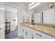 Well-lit bathroom featuring granite countertops, a large mirror, and ample cabinet space, combining style and functionality at 338 St. Julian Ln., Myrtle Beach, SC 29579