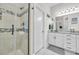 Bathroom showcasing tiled walk-in shower and white vanity with granite countertops and decorative lighting at 338 St. Julian Ln., Myrtle Beach, SC 29579