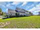 A gorgeous two-story home with ample lawn space, a porch, and stylish architecture creating a picturesque landscape at 338 St. Julian Ln., Myrtle Beach, SC 29579