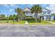 Two-story home featuring a double porch, palm trees, and a well-manicured front yard at 338 St. Julian Ln., Myrtle Beach, SC 29579
