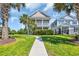 Charming two-story home with a double porch and lush landscaping with palm trees at 338 St. Julian Ln., Myrtle Beach, SC 29579