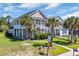 Charming two-story home featuring a double porch with palm trees and lush landscaping at 338 St. Julian Ln., Myrtle Beach, SC 29579