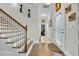 Open foyer with stairs and hardwood floors, featuring elegant sconces and an adjacent hallway at 338 St. Julian Ln., Myrtle Beach, SC 29579