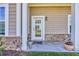 Inviting front porch featuring craftsman columns, a charming welcome mat, and tasteful decor at 338 St. Julian Ln., Myrtle Beach, SC 29579