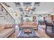 Bright, open-concept living room with comfortable seating, an ottoman, and seamless flow to the dining area at 338 St. Julian Ln., Myrtle Beach, SC 29579