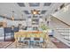 Open-concept living room with coffered ceilings, fireplace, kitchen island, and dining table at 338 St. Julian Ln., Myrtle Beach, SC 29579