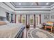 Spacious main bedroom with tray ceiling, dark hardwood floors, and three large windows providing natural light at 338 St. Julian Ln., Myrtle Beach, SC 29579