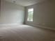 Bright bedroom features neutral carpet, paint, and a window for natural light at 3391 Moss Bridge Ln., Myrtle Beach, SC 29579