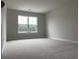 Bright bedroom with plush carpet and a large window at 3391 Moss Bridge Ln., Myrtle Beach, SC 29579