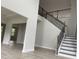 Open entryway with dark wooden staircase and neutral paint throughout at 3391 Moss Bridge Ln., Myrtle Beach, SC 29579