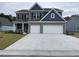 Attractive two-story home boasting a gray brick facade, a two-car garage, and a beautifully patterned driveway at 3391 Moss Bridge Ln., Myrtle Beach, SC 29579