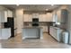Modern kitchen features white cabinets, granite countertops, and stainless steel appliances at 3391 Moss Bridge Ln., Myrtle Beach, SC 29579