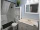 Clean bathroom with a shower-tub combination and bright white fixtures at 3401 Dunes St. # A3, North Myrtle Beach, SC 29582