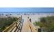 Picturesque wooden walkway leading to a pristine sandy beach with people enjoying the ocean at 3401 Dunes St. # A3, North Myrtle Beach, SC 29582