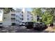 Condo exterior showcasing white staircases, yellow paint, and parking spaces at 3401 Dunes St. # A3, North Myrtle Beach, SC 29582