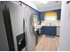 Updated kitchen with stainless steel refrigerator and dark blue cabinets at 3401 Dunes St. # A3, North Myrtle Beach, SC 29582