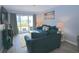 Cozy living room with a comfortable blue sofa and sliding glass door to outdoor space at 3401 Dunes St. # A3, North Myrtle Beach, SC 29582